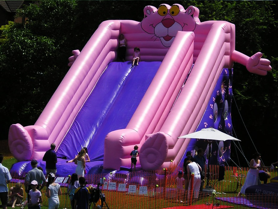 children play on giant inflatable slide in london